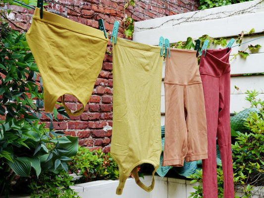 Sportswear hanging from a clothesline in a backyard