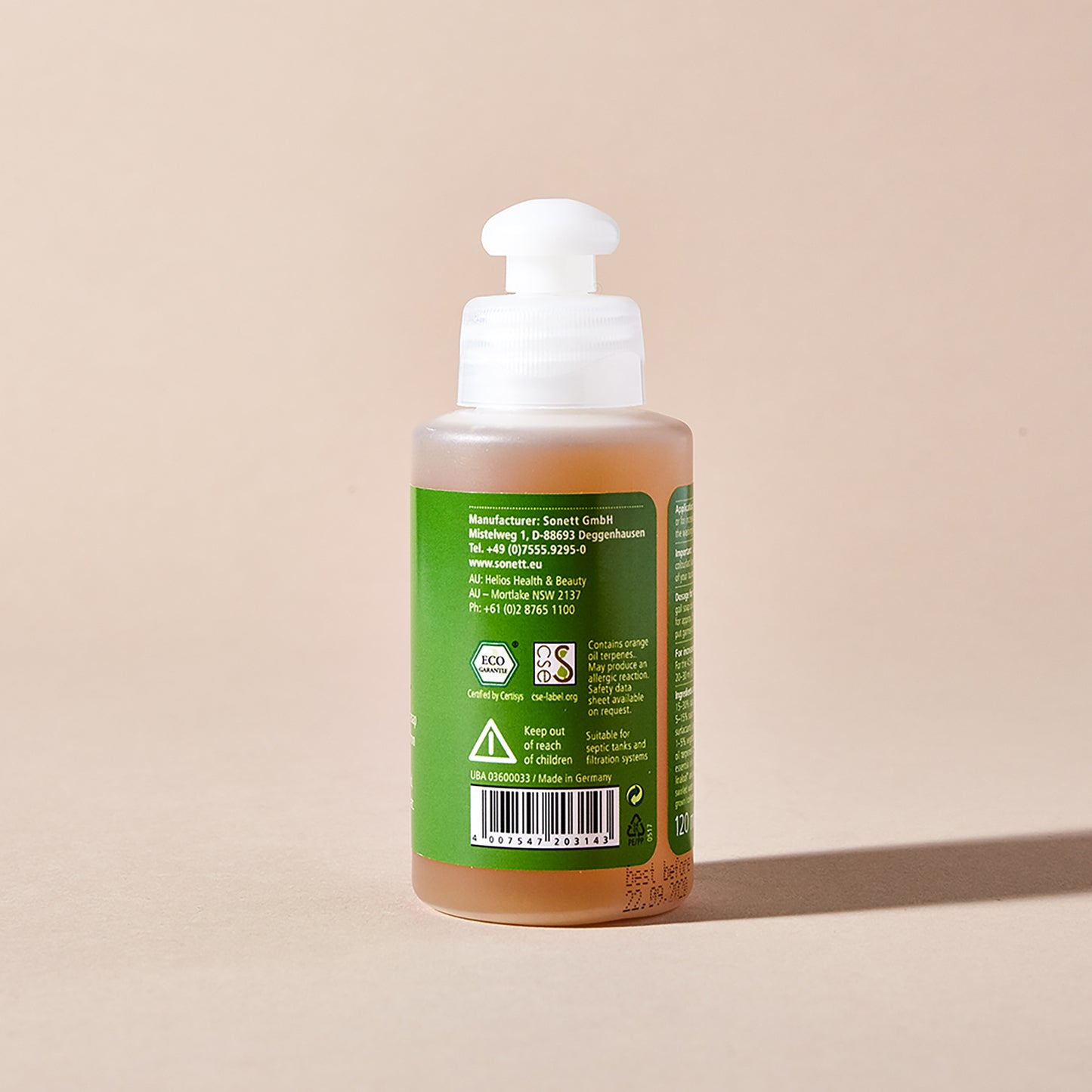 The backside of a bottle of Sonett liquid gall soap for stain removal with a green label