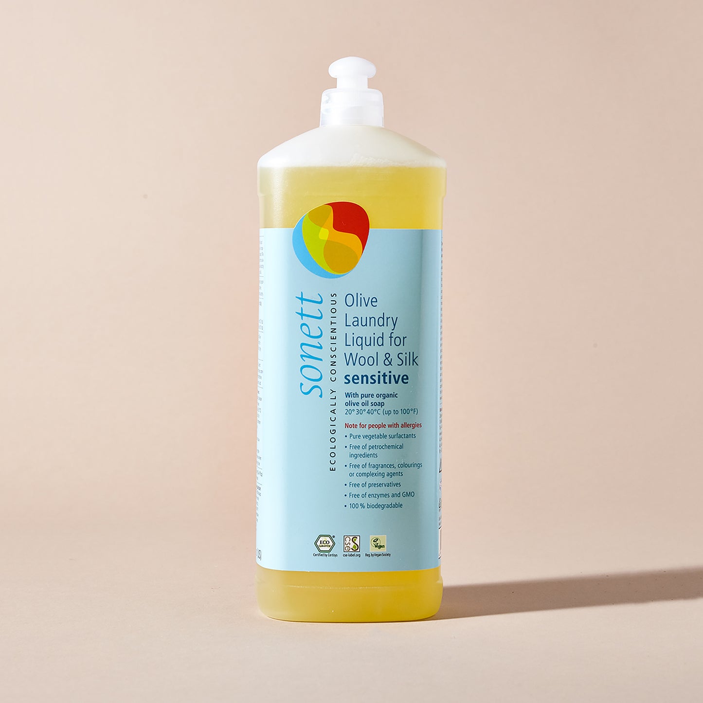 A squeeze bottle of Sonett olive detergent for wool and silk with a blue label