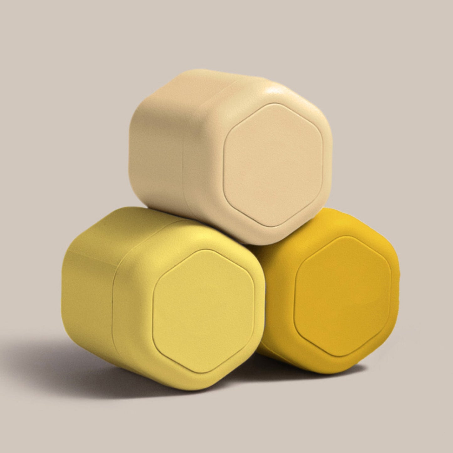 Three stacked Cadence travel capsules in various shades of yellow