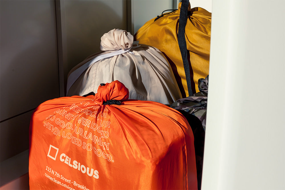 Four neatly knotted laundry bags in the morning light