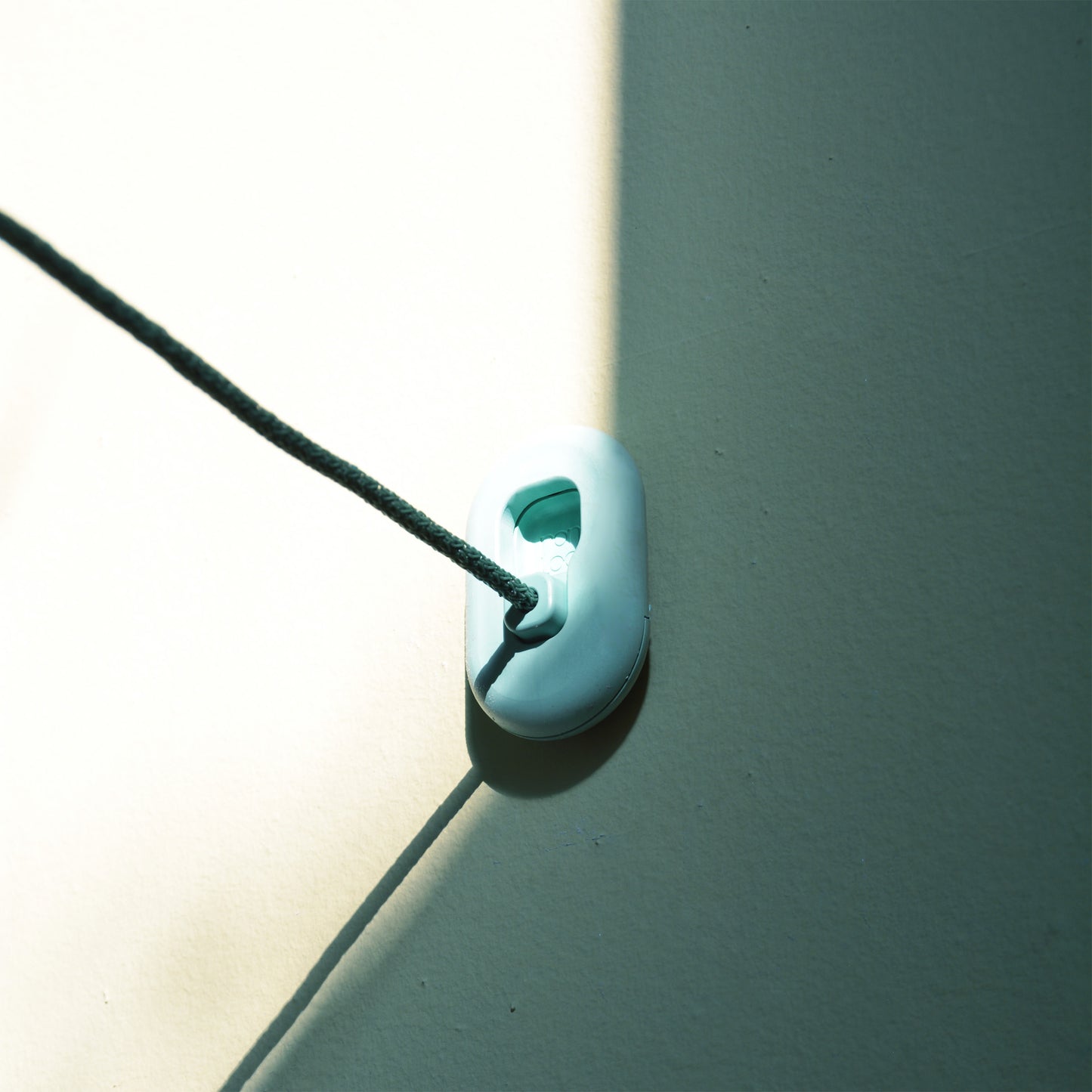 The LOOP clothesline by NONA connects to a wall mount made from recycled fishing rope