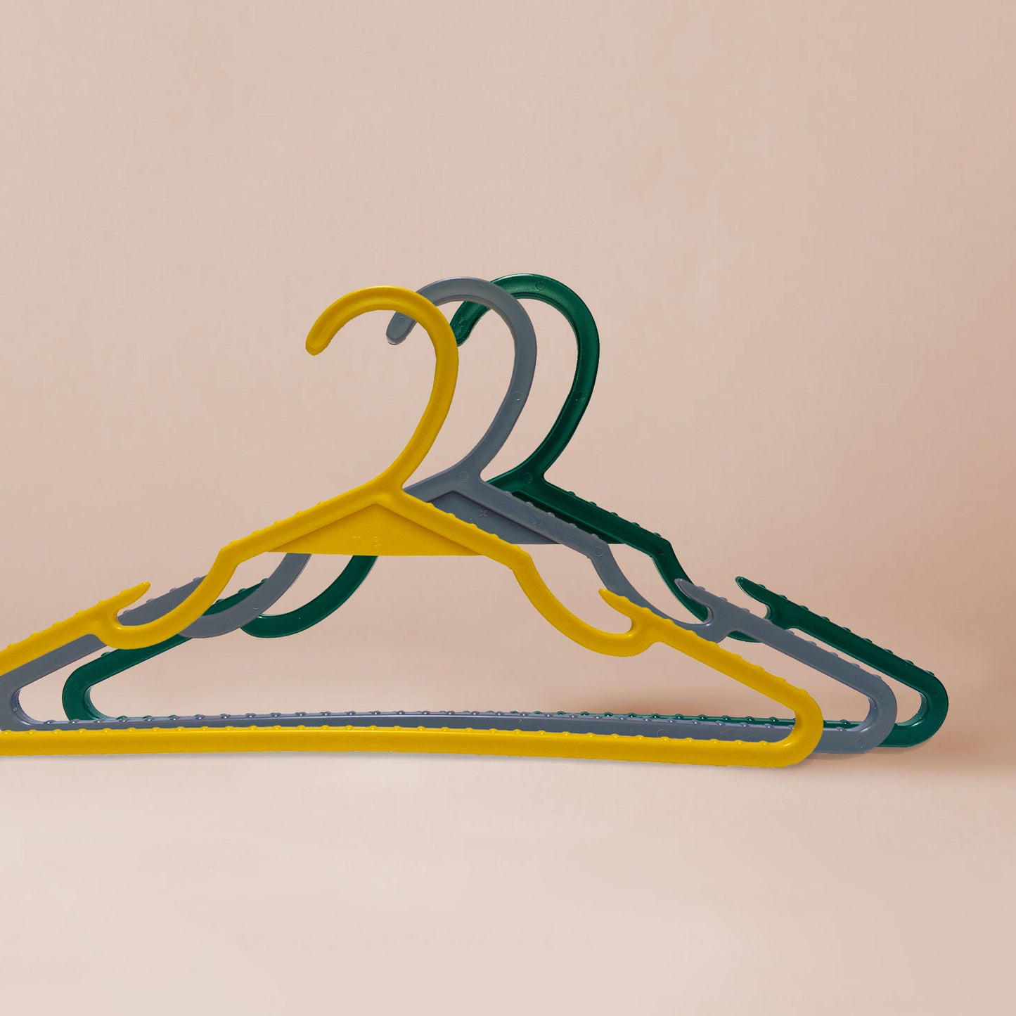 Yellow, grey, and emerald green high-quality hangers made by the brand Re to the X