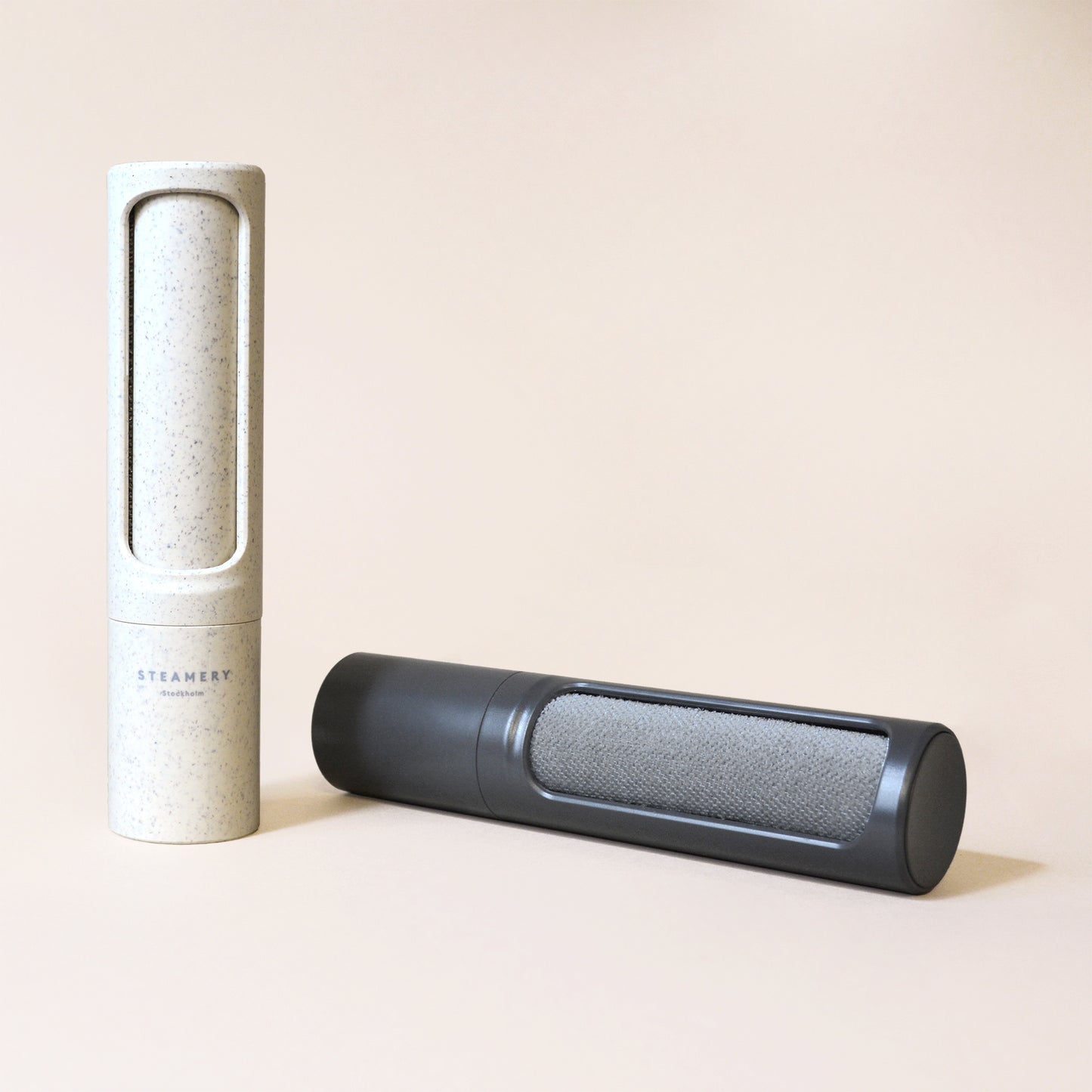 Two reusable lint removers by Steamery, one charcoal and one beige
