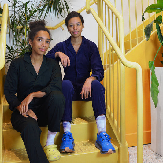 The Williams sisters on a staircase at Celsious in jumpsuits