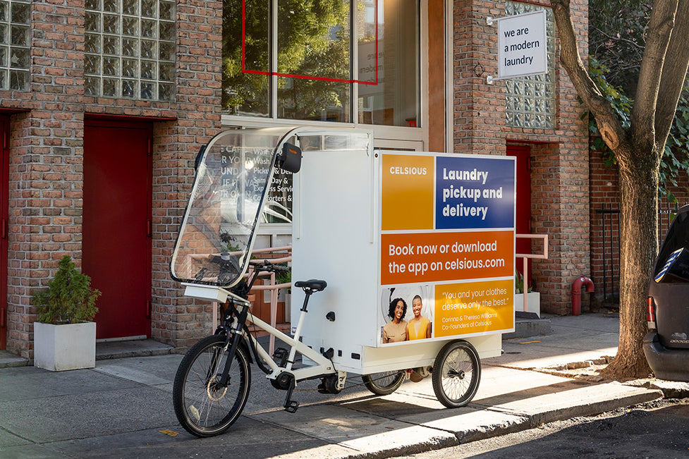 A colorful e-bike for laundry deliveries parked outside Celsious