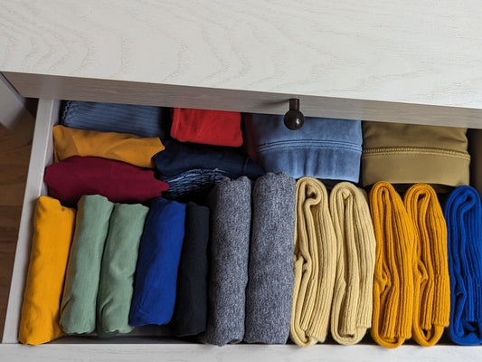 An open drawer of neatly folded clothes