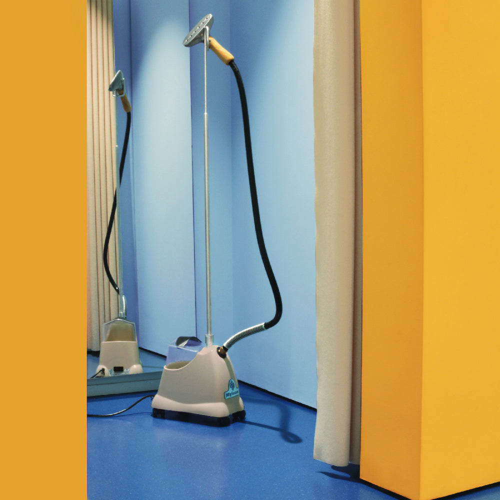 A beige upright steamer with a metal head in a boutique's blue and yellow changing room