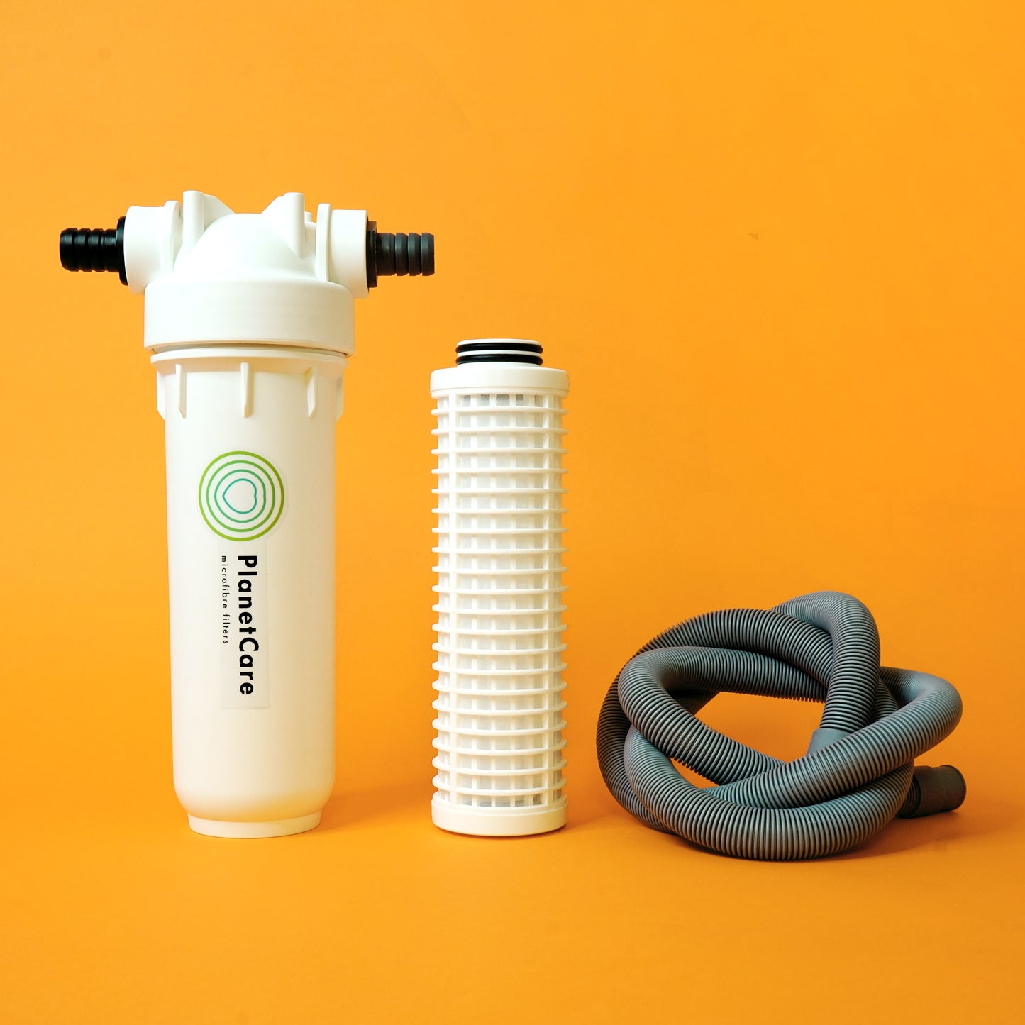 The PlanetCare microfiber filter, an at-home solution for microplastic pollution. Pictured here: the cartridge housing, a cartridge and a drain hose wrapped in a pretty knot