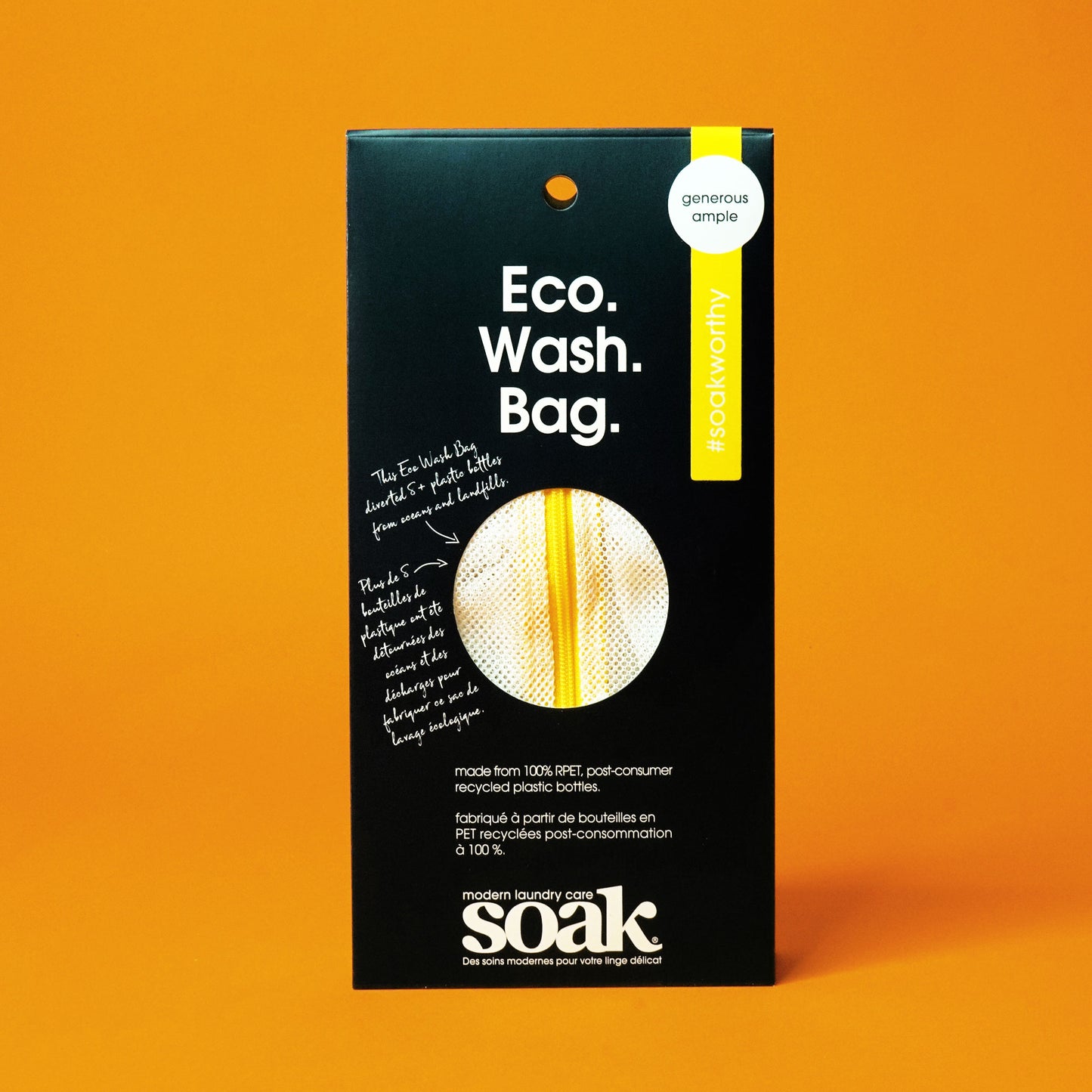 A black rectangular package with a circle cutout showing a mesh material with yellow zipper. The box reads "Eco. Wash. Bag."