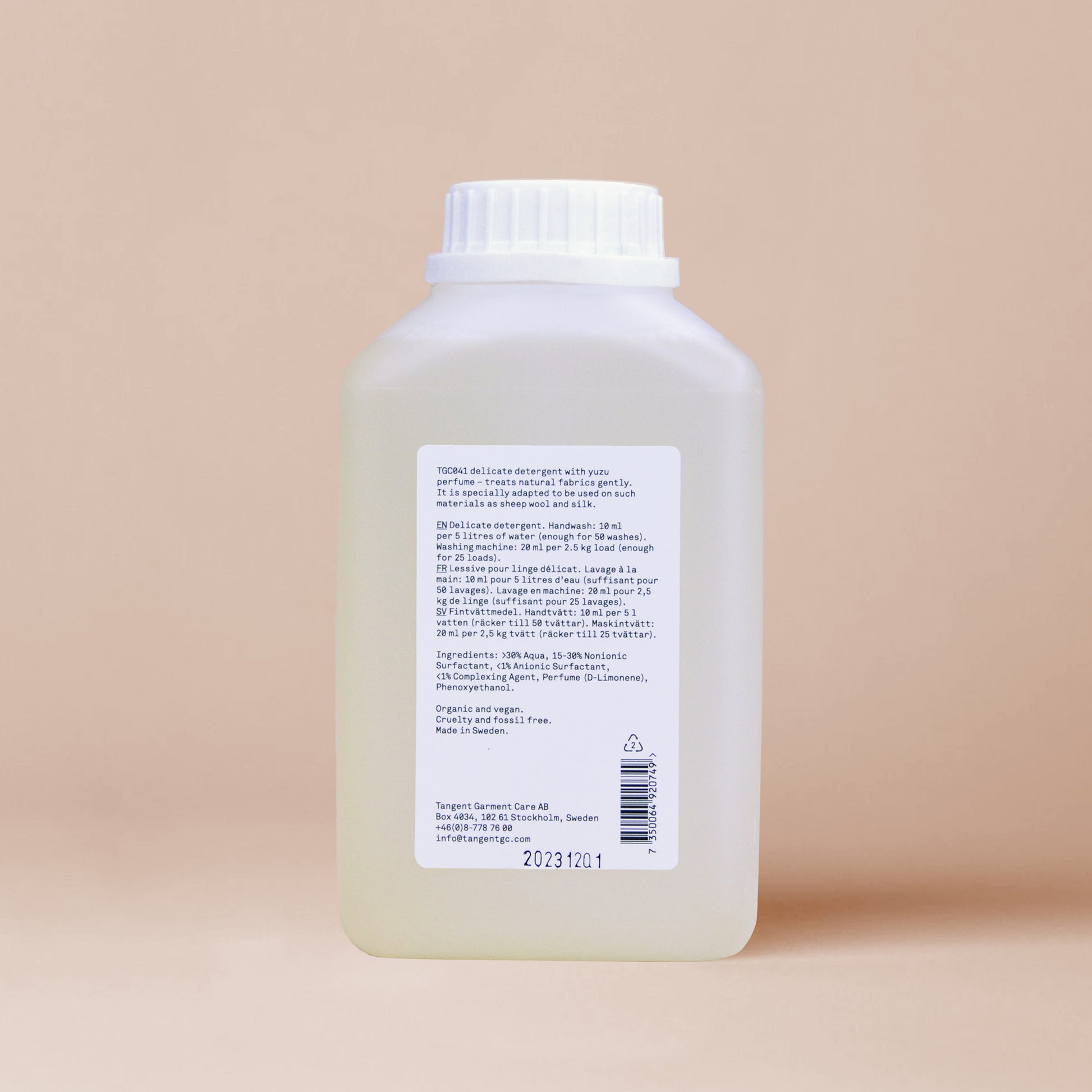 The back of an elegant bottle of yuzu delicate detergent from Tangent Garment Care with ingredient info and usage instructions