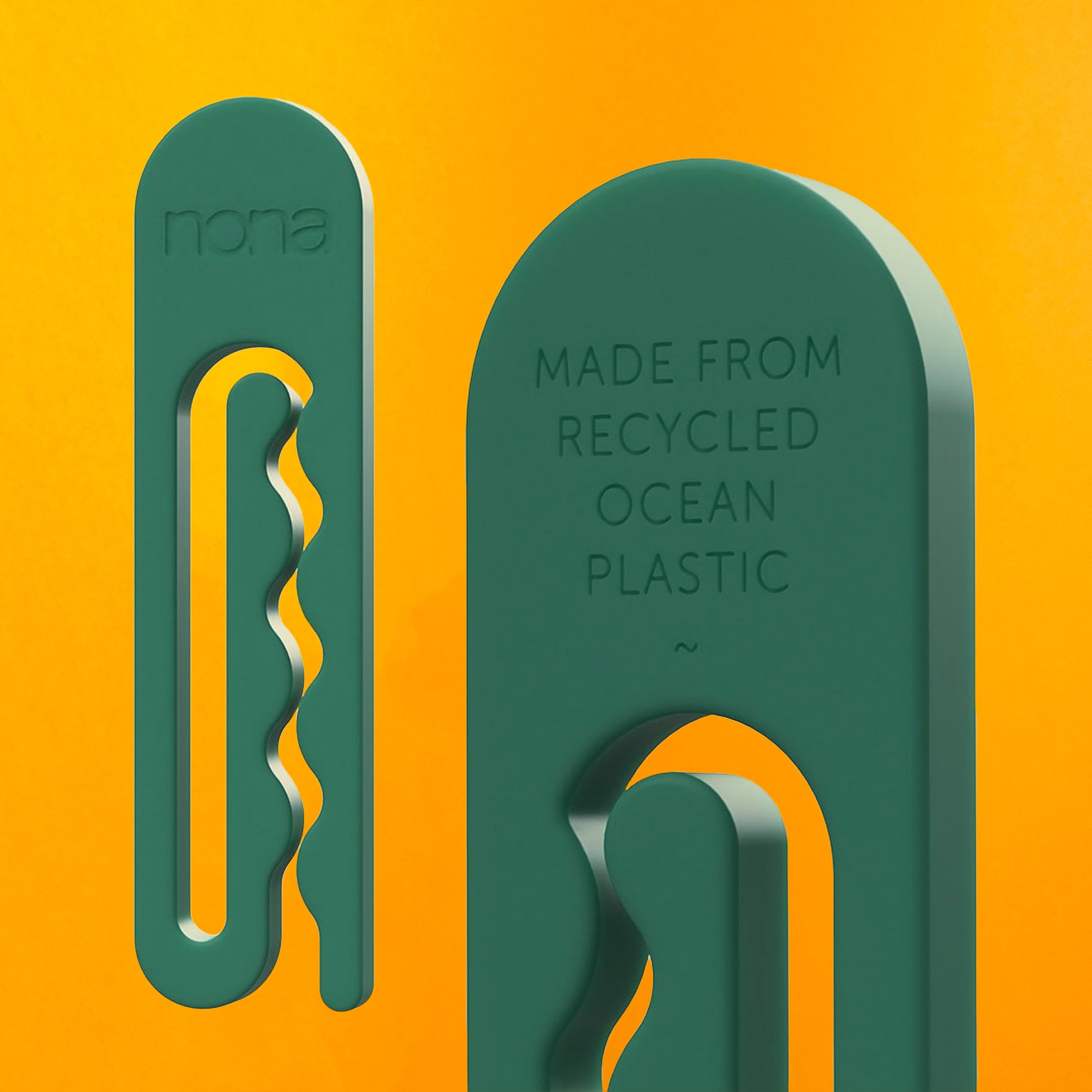 A green clothespin with the word "nona" and a close up of the other side, which reads "made from recycled ocean plastic"