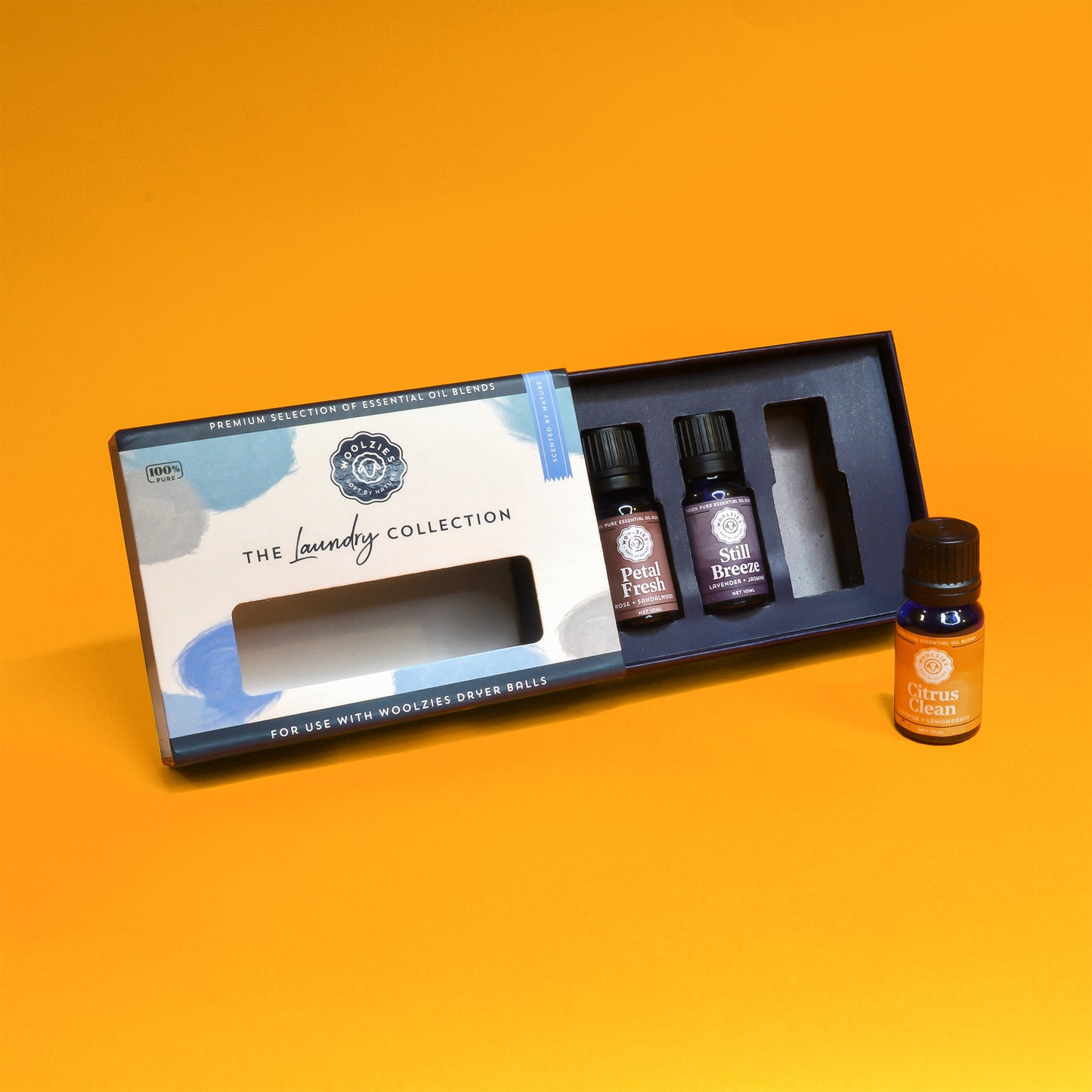 An open box showing a set of three vials of essential oils for laundry by Woolzies