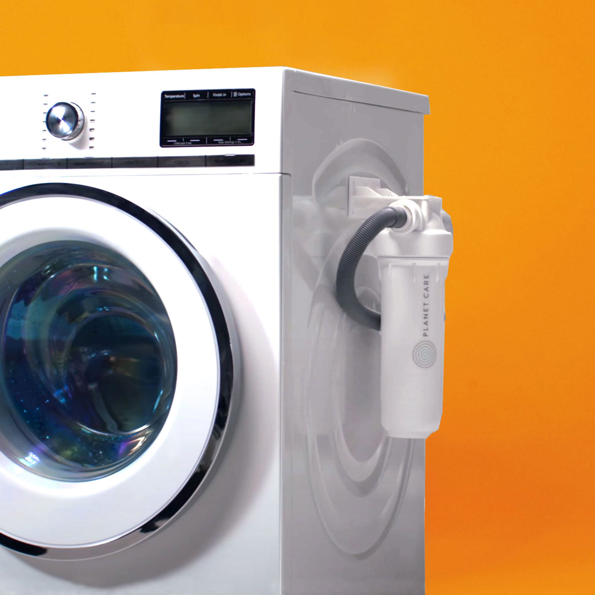 A white washing machine installed with the PlanetCare microfiber filter on the side