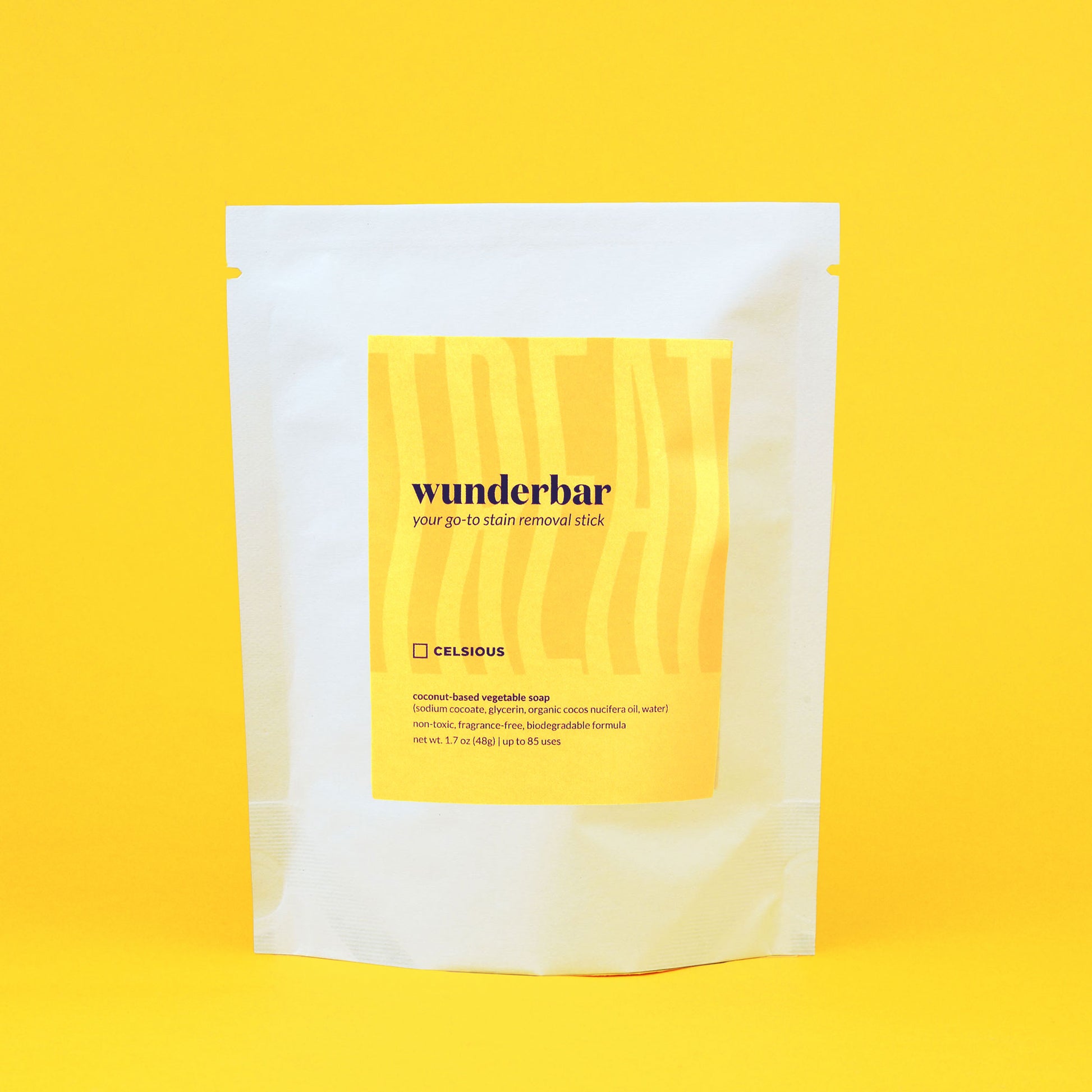 A white pouch with a yellow and orange label containing Wunderbar soap stick, displayed with a yellow backdrop